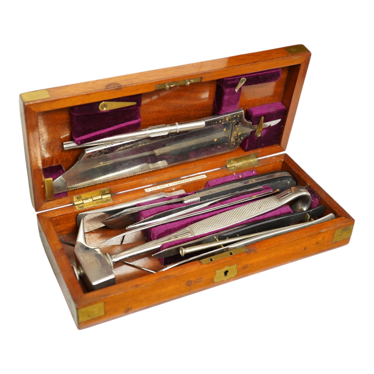 A 19th century mahogany cased surgeon’s set of steel surgical instruments by S. Maw Son & Thompson, London, comprising of an amputation saw, scalpel, a hammer, etc., dimensions of the case; 23.5cm wide, 10.5cm deep, 4cm